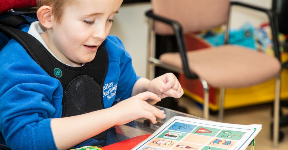 young boy with physical disabiltiy smiling